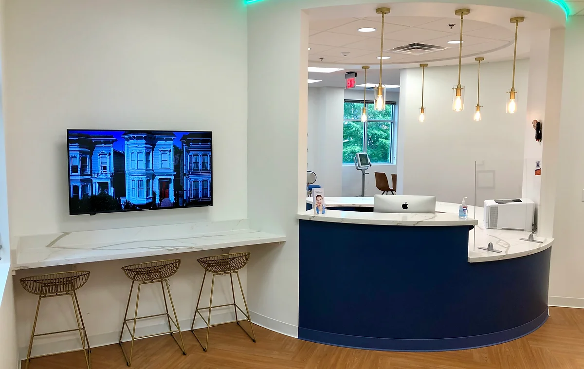 Waiting room view toward front desk and clinic bay at braces, invisalign, and inbrace provider, genuine orthodontics, in Brentwood, TN